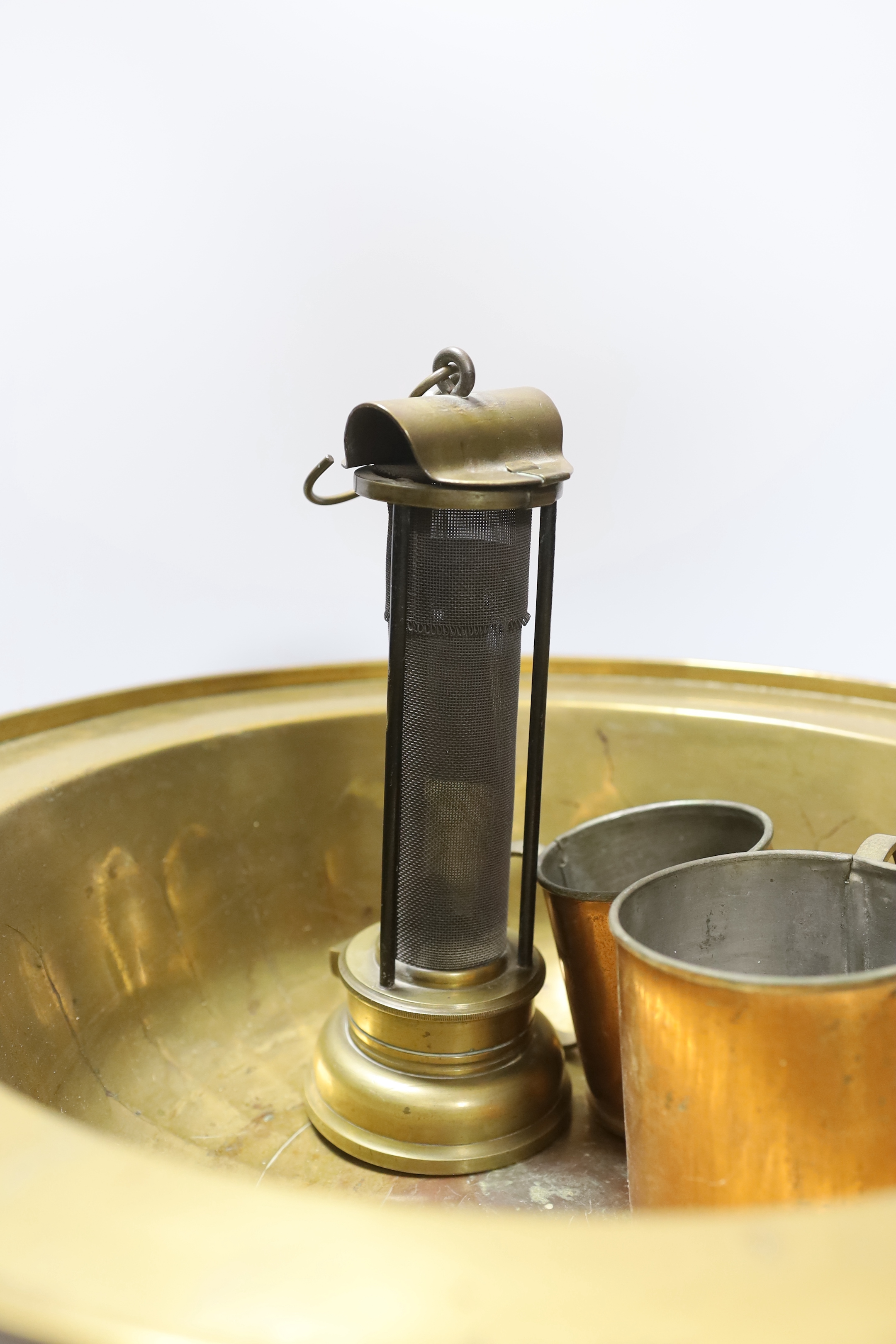 A miner's brass Davy lamp, signed E.Thomas & Williams, a large brass bowl and three graduated copper measures